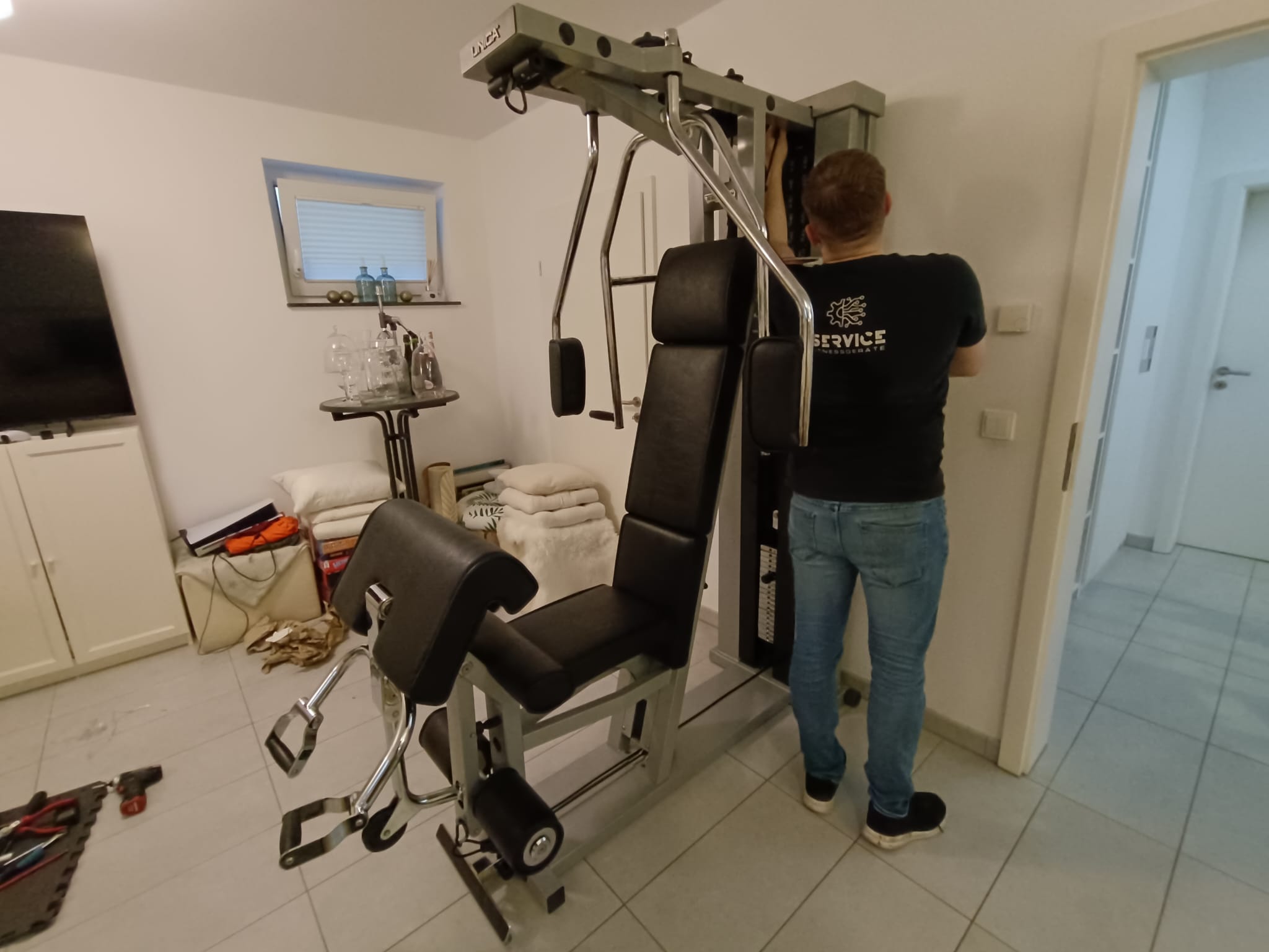 Technician servicing commercial strength fitness equipment